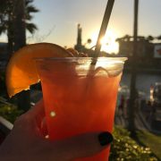 Grabbing a cocktail before Mardi Gras on CityWalk with Toothsome Chocolate Emporium & Savory Feast Kitchen in the background